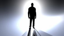 A silhouette of humanlike figure against a bright light to illustrate the article What Does the Bible Say About Angels?