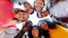 Photo looking up at a circle of friendly faces to illustrate the article Become All Things to All Men