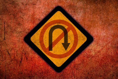 Graphic of a stylized no U-turn sign to illustrate the article Are We at the Point of No Return?