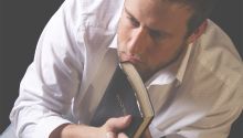 Photo of a man holding a Bible with a serious expression on his face. This illustrates the article Does the Bible Make You Uncomfortable?