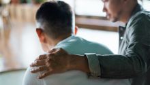 Photo of a man with his hand on the shoulder of another man to illustrate the article How to Confess Your Sins to One Another