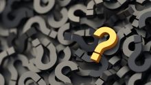 Yellow question mark on a pile of question marks to illustrate the article How to Understand Confusing Bible Verses