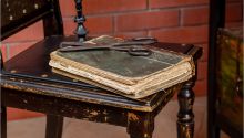 The Danger of Cut-and-Paste Christianity. Photo of ancient Bible with scissors on top.