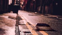 Photo of a Bible on a city street at night, to illustrate the article Truth Is Fallen in the Street