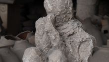 A photo of a cast made from a body found buried in Pompeii, to illustrate the article The Fate of Those Who Died in Pompeii