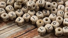 Photo of a jumble of letter cubes to illustrate the article 